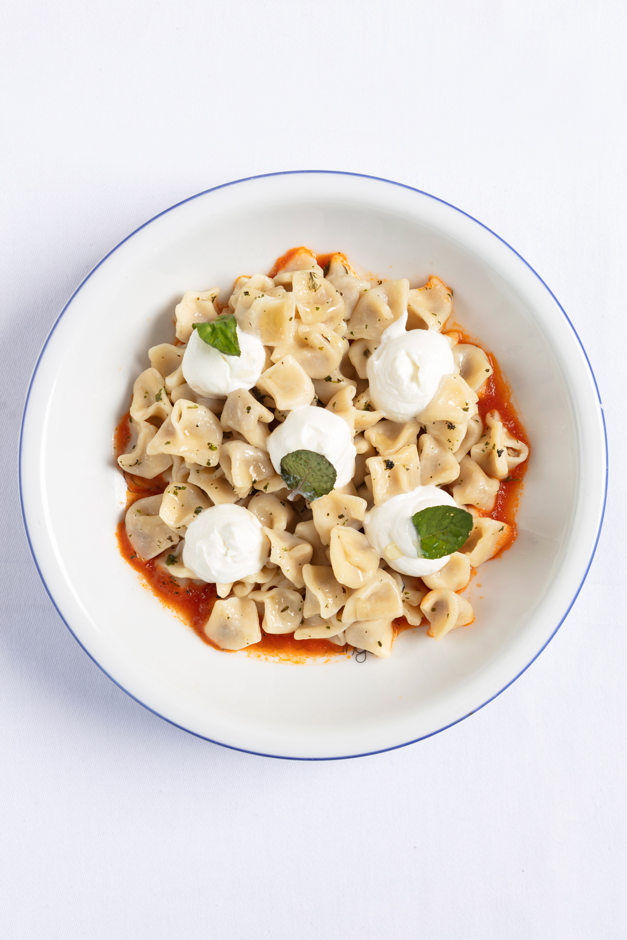 Yogurt, ravioli dumplings with tomato sauce